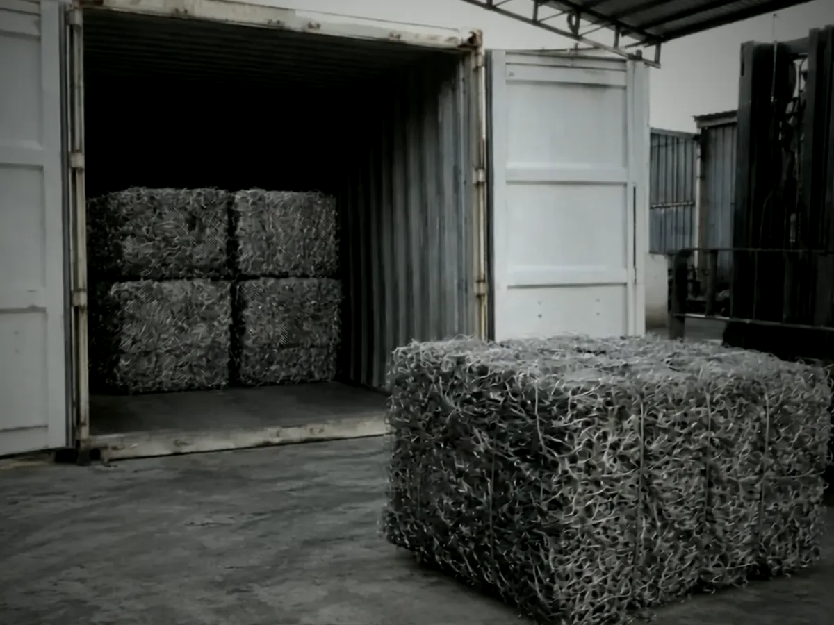 Loading bales into a container
